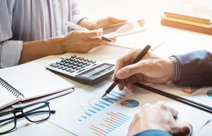 business man financial inspector and secretary making report, calculating or checking balance. Internal Revenue Service inspector checking document. Audit concept